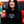 Load image into Gallery viewer, Woman wearing a black 'Wisconsin Up' sweatshirt holding a red cup with a Jeep in the background