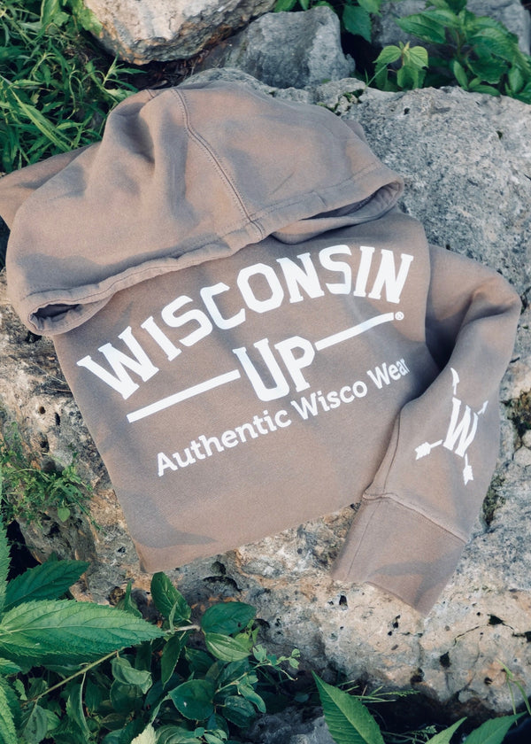 Brown hoodie with 'Wisconsin Up' text on a rocky surface