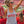 Load image into Gallery viewer, A woman cheering at a stadium wearing a heather gray tank top with 'WISCO' printed in red across the chest, paired with denim shorts and sunglasses. She is holding a red and white pom-pom.
