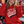 Load image into Gallery viewer, A young girl cheering at a sports event, wearing a red hoodie with 'LET'S GO Wisco' printed in white and black. She has 'W' face paint on her cheek and is sitting in stadium bleachers with other fans in the background.
