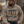 Load image into Gallery viewer, A man wearing a beige hoodie with 'WISCONSIN FALL SOCIAL CLUB' printed on the front, sitting outdoors by a campfire and holding a mug.
