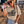 Load image into Gallery viewer, Woman at a music festival wearing a t-shirt with text, denim shorts, and a straw hat.
