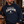 Load image into Gallery viewer, A man wearing a navy blue hoodie with 'MEET ME AT THE TAVERN WISCONSIN UP!' printed on the front, standing at a wooden bar in a rustic bar setting.
