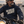 Load image into Gallery viewer, A man with a graying beard and sunglasses rides a motorcycle on a highway, wearing a navy blue hoodie with 'WISCO BENT' printed in white across the chest.
