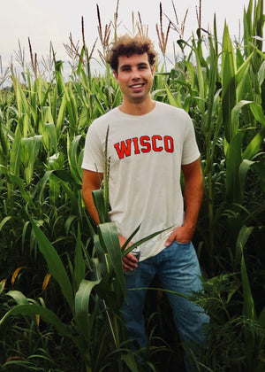 Person wearing a 'WISCO' t-shirt standing in a cornfield