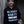 Load image into Gallery viewer, Man wearing a hoodie with &#39;Bloody Marys are Breakfast&#39; text, holding a drink against a textured wall.
