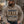 Load image into Gallery viewer, A man wearing a beige hoodie with 'WISCONSIN FALL SOCIAL CLUB' printed on the front, sitting outdoors by a campfire. He is wearing a brown and gray trucker hat with 'RIP U' on the patch.
