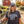 Load image into Gallery viewer, Woman wearing a 'Wanna Bet' shirt and cap standing in a farm setting with cows and a red barn.
