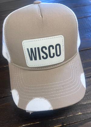 Tan trucker hat with WISCO leather patch, adjustable snapback, and breathable mesh back.