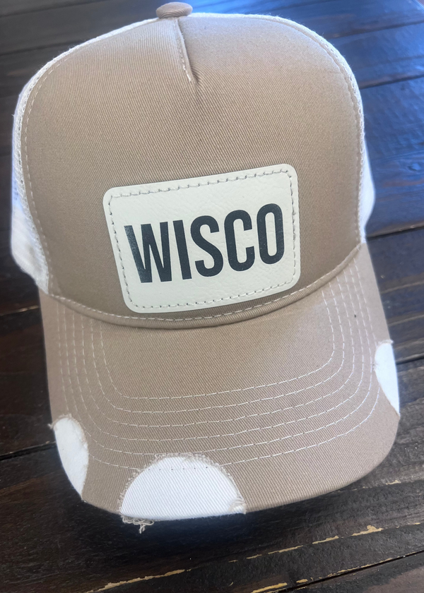 Tan trucker hat with WISCO leather patch, adjustable snapback, and breathable mesh back.