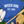 Load image into Gallery viewer, Blue t-shirt with 'WISCO GIRL EST. 1848' text, white sneakers, baseball bat, and glove on grass.
