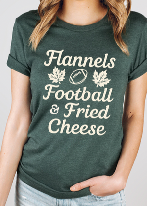 Person wearing a green t-shirt with 'Flannels Football & Fried Cheese' text and graphics.