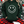 Load image into Gallery viewer, Person wearing a green hoodie with a smiley face design and red plaid pants in front of Christmas trees.
