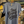 Load image into Gallery viewer, Light blue t-shirt with 'Stay Classy Wisco' text on a hanger in a store setting.
