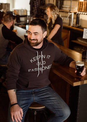 Softest vintage-inspired “Keepin' It Old Fashioned” hoodie for Wisconsin Up brand, perfect for Wisconsin lovers. Man wearing it.