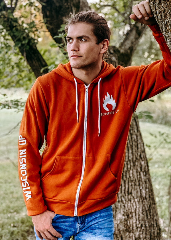"Bonfire Up" zip-up hoodie, perfect for staying warm during outdoor adventures and bonfire nights. On male model.