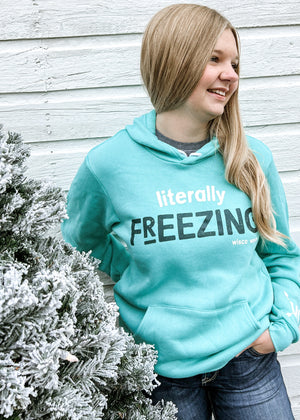 "Literally Freezing" hoodie for cold weather enthusiasts, perfect for staying warm in winter. On a female model.
