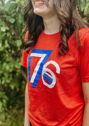 Patriotic 1776 shirt with vintage design, perfect for celebrating American pride. On a young lady.