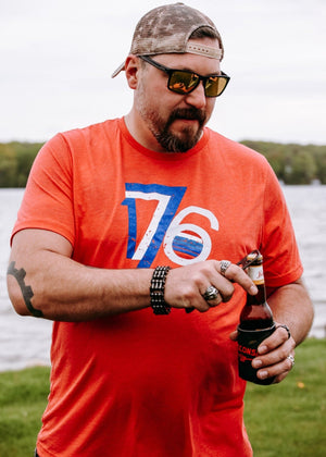 Patriotic 1776 shirt with vintage design, perfect for celebrating American pride. On a large male.