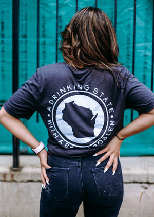 "Drinking State with a Beer Problem" shirt for Wisconsin beer lovers, featuring a fun, bold design. Back view on a woman.