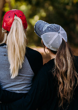 Distressed red ponytail hat with bold "W" on front, perfect for Wisconsin fans. Back view of ponytail.