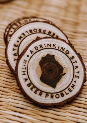 Set of 4 hand-stamped wood coasters featuring "A Drinking State With a Beer Problem" slogan.